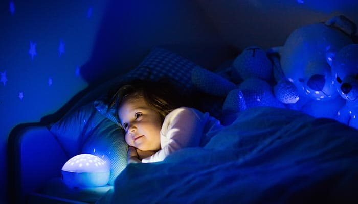 little girl reading in bed